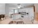 Well-lit kitchen with white cabinetry, appliances, and view into the dining area at 2213 Genesis Dr, Monroe, NC 28110