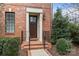 Inviting front entrance with brick steps and a stylish wooden door with glass panel at 2218 Croydon Rd, Charlotte, NC 28207