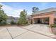 Two car garage (open) with a concrete drive and brick border that enhances the curb appeal of this home at 2218 Croydon Rd, Charlotte, NC 28207