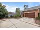 Two car garage with a concrete drive and brick border that enhances the curb appeal of this home at 2218 Croydon Rd, Charlotte, NC 28207