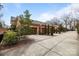 Four-car garage with concrete drive and brick border adds to the curb appeal of this stunning home at 2218 Croydon Rd, Charlotte, NC 28207