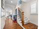 Bright foyer with hardwood floors, staircase, and view into the living room at 2218 Croydon Rd, Charlotte, NC 28207