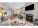 Open concept living room with a fireplace, hardwood floors, and ample natural light at 2218 Croydon Rd, Charlotte, NC 28207