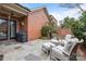 Back patio area with beautiful stonework and ample seating, ideal for entertaining guests at 2218 Croydon Rd, Charlotte, NC 28207