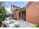 Inviting outdoor patio with comfortable seating, perfect for entertaining and relaxing by the red brick house at 2218 Croydon Rd, Charlotte, NC 28207