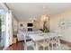 Bright dining area with white table and chairs, open to the living room at 232 Morgans Branch Rd, Belmont, NC 28012