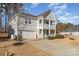 Two-story house with gray siding, a two-car garage, and a front porch at 232 Morgans Branch Rd, Belmont, NC 28012