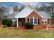 Brick ranch house with landscaped yard and a charming front porch at 234 Henson Ln, McConnells, SC 29726