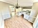 Bright dining area with hardwood floors and a view into the living room at 2711 Thornbush Ct, Charlotte, NC 28270