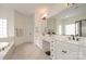 Elegant Primary bathroom with dual sinks, white cabinetry and a relaxing tub at 3013 Misty Moss Ct, Waxhaw, NC 28173