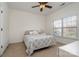 Comfortable bedroom with neutral carpeting, ceiling fan, and a window that provides natural light at 3013 Misty Moss Ct, Waxhaw, NC 28173