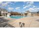 Large community pool with a waterslide, surrounded by ample lounging space and lush landscaping at 3013 Misty Moss Ct, Waxhaw, NC 28173