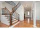 Bright foyer with hardwood floors, staircase, and decorative columns at 3013 Misty Moss Ct, Waxhaw, NC 28173