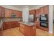 Modern kitchen featuring granite countertops, stainless steel appliances, and wooden cabinetry at 3013 Misty Moss Ct, Waxhaw, NC 28173