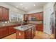 Well-lit kitchen with granite countertops, stainless steel appliances, and central island sink at 3013 Misty Moss Ct, Waxhaw, NC 28173