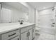 Modern bathroom with white vanity, bathtub, and shower at 3209 Whispering Creek Dr, Indian Trail, NC 28079