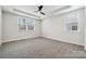 Spacious bedroom with ceiling fan and grey carpeting at 3209 Whispering Creek Dr, Indian Trail, NC 28079