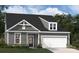 Gray two-story house with white garage door and landscaping at 3209 Whispering Creek Dr, Indian Trail, NC 28079