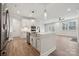 Modern kitchen with white cabinets, stainless steel appliances and island at 3209 Whispering Creek Dr, Indian Trail, NC 28079