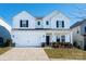 Two-story white house with black shutters, two-car garage, and landscaping at 3962 Isenhour Rd, Kannapolis, NC 28081