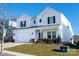 Two-story white house with black shutters, two-car garage, and landscaping at 3962 Isenhour Rd, Kannapolis, NC 28081