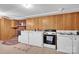 Basement kitchenette with white cabinets and electric stove at 421 Wood Bridge Rd, Statesville, NC 28625