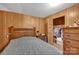 Cozy bedroom with wood-paneled walls, a double bed, and ample closet space at 421 Wood Bridge Rd, Statesville, NC 28625