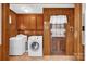 Laundry room with washer, dryer, and wooden cabinets at 421 Wood Bridge Rd, Statesville, NC 28625