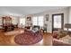 Living room with hardwood floors, vintage furniture, and view to dining area at 421 Wood Bridge Rd, Statesville, NC 28625