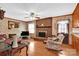 Living room with brick fireplace, hardwood floors, and a ceiling fan at 421 Wood Bridge Rd, Statesville, NC 28625