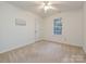 Cozy carpeted bedroom with a window and neutral walls at 4211 Suttle Pl, Matthews, NC 28104