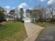 House exterior with a driveway and lawn at 4211 Suttle Pl, Matthews, NC 28104