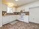 White kitchen with tile backsplash and modern appliances at 4211 Suttle Pl, Matthews, NC 28104