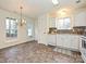 Eat-in kitchen with white cabinets and tile floor at 4211 Suttle Pl, Matthews, NC 28104