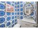 A vibrant half-bathroom with floral wallpaper, white vanity, and decorative mirror at 4334 Silo Ln, Charlotte, NC 28226