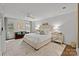 Spacious bedroom with a seating area, neutral color palette and large windows at 4334 Silo Ln, Charlotte, NC 28226