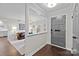 Bright entryway featuring a gray front door, hardwood floors, and an open view into the living room at 4334 Silo Ln, Charlotte, NC 28226