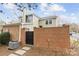 Back exterior view of home with brick wall providing privacy at 4334 Silo Ln, Charlotte, NC 28226