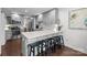 A bright kitchen with an island, stainless appliances, light grey cabinetry, hardwood flooring, and marble countertops at 4334 Silo Ln, Charlotte, NC 28226