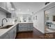 Kitchen area featuring modern grey cabinetry, a peninsula countertop, and hardwood flooring at 4334 Silo Ln, Charlotte, NC 28226