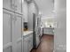 Bright, modern kitchen featuring stainless steel appliances, grey cabinetry and hardwood floors at 4334 Silo Ln, Charlotte, NC 28226