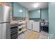 Well-organized laundry room featuring modern appliances, blue cabinetry and lively wallpaper at 4334 Silo Ln, Charlotte, NC 28226