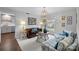 Cozy living room with stylish furnishings, artwork, a large window, and a decorative chandelier at 4334 Silo Ln, Charlotte, NC 28226