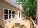 Expansive wooden back deck with views of the lush, mature trees in the backyard at 4607 Ferguson Cir, Waxhaw, NC 28173