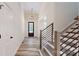 Modern foyer features staircase with wood steps and metal railing at 4607 Ferguson Cir, Waxhaw, NC 28173