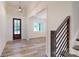 Welcoming foyer with wood floors, stairs, and a modern front door at 4607 Ferguson Cir, Waxhaw, NC 28173