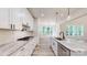 Bright kitchen featuring granite countertops, island with sink, subway tile backsplash, and stainless steel appliances at 4607 Ferguson Cir, Waxhaw, NC 28173
