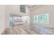 Open-concept living area with kitchen, great natural light, hardwood floors, and neutral color palette at 4607 Ferguson Cir, Waxhaw, NC 28173