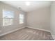 Empty bedroom featuring neutral walls, carpet, and two windows at 5115 Waterloo Dr, Fort Mill, SC 29708