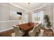 Formal dining room featuring a modern chandelier, large window, and neutral wall color at 5115 Waterloo Dr, Fort Mill, SC 29708